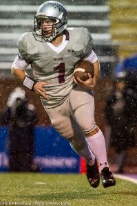 Tornado quarterback Peyton Wall looks for running room in the rain.