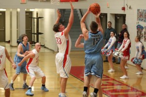 Hardin Valley's Zac Carter puts up a shot while defended by Heritage's Hunter Bailey.