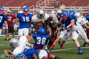 Mitchell (60) squeezes in front of an Alcoa ball carrier on Friday.