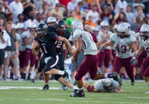 Rebel quarterback Tyler Vaught escapes upfield on the offensive play of the game early in the opening half.