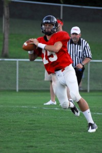 Philip Juhlin rolls to throw during a scrimmage his senior season with the Rebels.