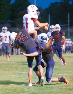 Heritage's Riley Hill comes down with the touchdown catch as William Blount's Reed Daniels and ? defend. Daniels was injured on the play.