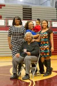 Pat Whitted, mother of former Alcoa basketball player Terry Whitted, holds up a photograph she carries of her late son. With her, from left, are Terry's widow, Lisa, daughter, Briana, granddaughter, Brooklyn, and daughter, Angel.