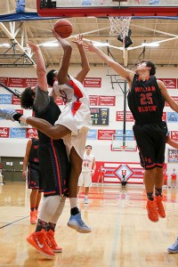 Heritage's ? Berger squeezes to the basketball against William Blount's Jai Atkins and Corey Pyle.
