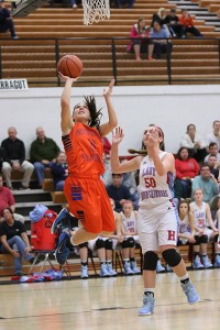Lindsey Roddy glides to the basket ahead of Heritage's Katie Wolfe.