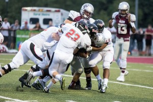 Maryville's Blake Oliveira, left, Tyler Zwolinski (23) and Trajuan Purty (44) swarm an Alcoa ball carrier.