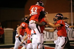 Joel Hopkins (43) is lifted in celebration after a touchdown catch from younger brother, Dylan (1), at right.