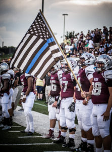 The flag held by senior Austin Porter (98), Alcoa pays tribute to fallen Maryville police officer Kenny Moats. Blount Press Row offers its prayers to the family of officer Moats. 