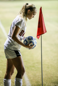 Abby Kolarik sets the ball for a corner kick.