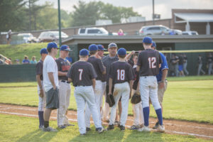 The Wildcats talk things over between innings.